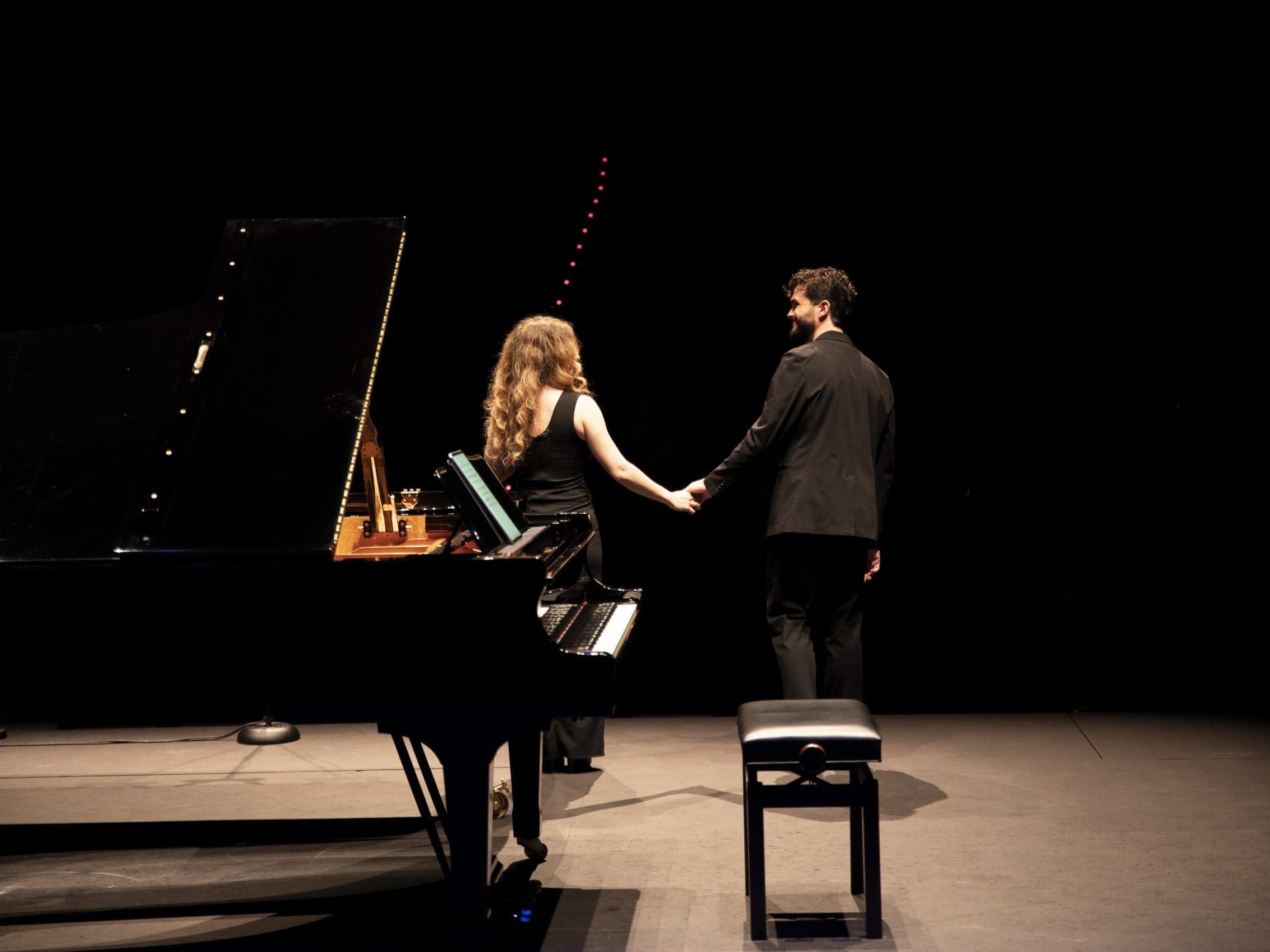 Ikigai Duo looking at each other during a standing ovation